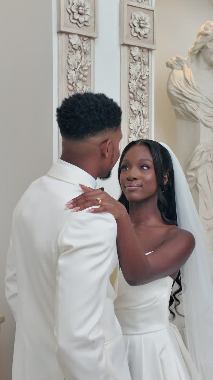 A couple dancing together at a white wedding reception